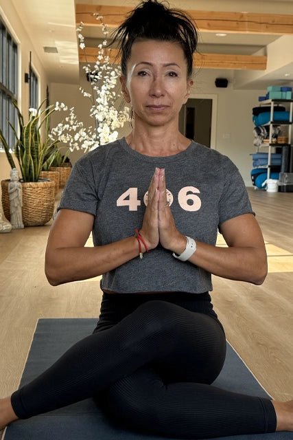 JaneLe sitting on yoga mat ready to teach her incredible class in a peaceful yoga room